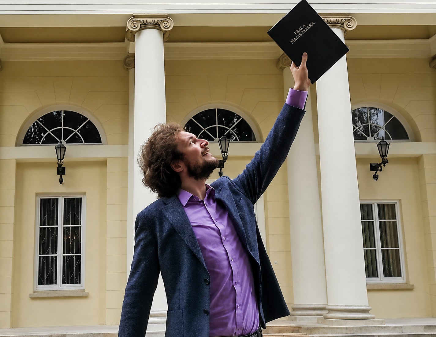 Michal Maciejewski in front of University of Warsaw Observatory, with a master thesis